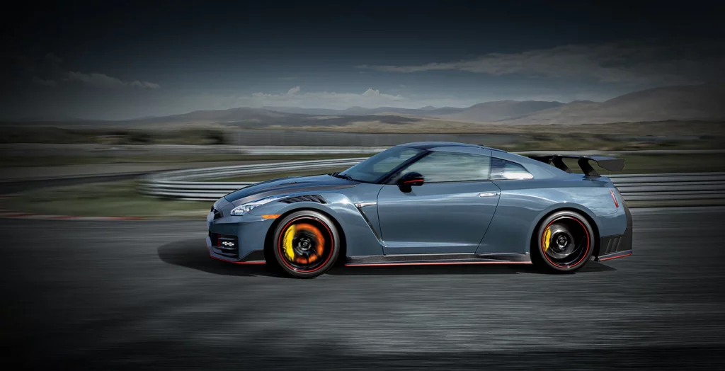2024 nissan gt r nismo side view driving down racetrack v2
