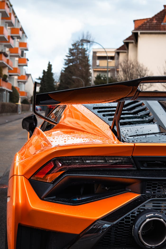 Vibrant orange Lamborghini Huracan STO parked on a street in Frankfurt, showcasing its elegant design and sporty features.
